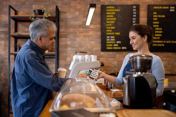 istock Man making a contactless payment at a cafe 1388431002