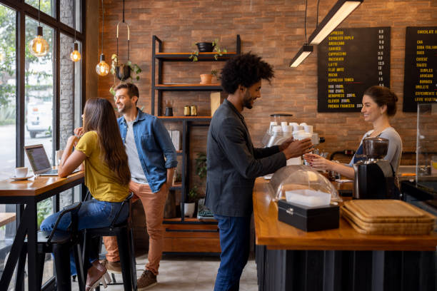 istock Man at a cafe buying coffees to go 1388431007