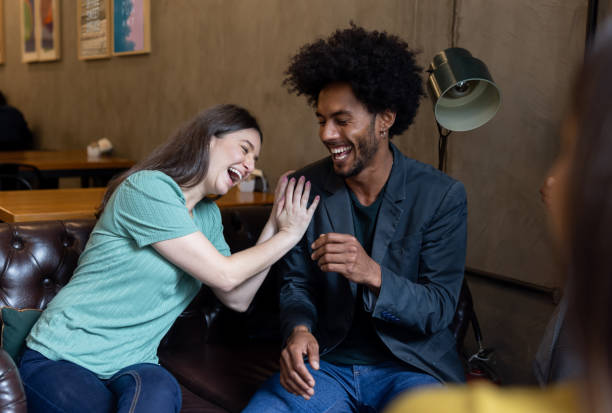 istock Happy couple laughing at a restaurant 1388431046