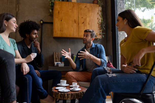 istock Happy group of friends talking at a cafe 1388431048
