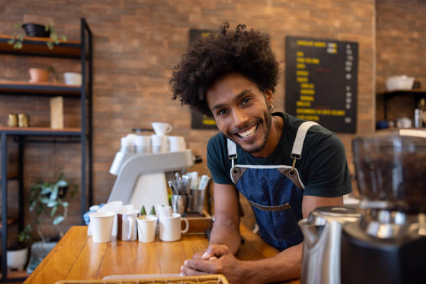 istock Happy barista working at a cafe 1388431067