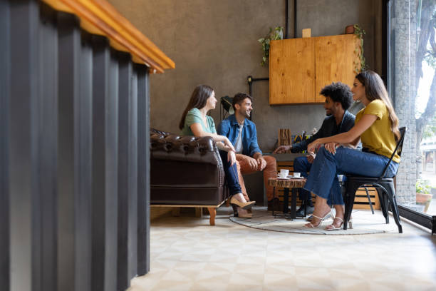 Happy group of Brazilian friends talking at a cafe while having a cup of coffee