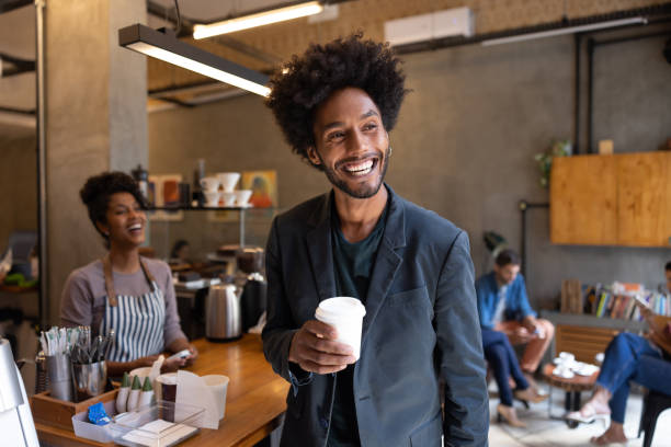 istock Happy man at a cafe buying coffee to go 1388431096