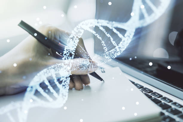 istock Creative concept with DNA symbol illustration and hand writing in notebook on background with laptop. Genome research concept. Multiexposure 1388431615