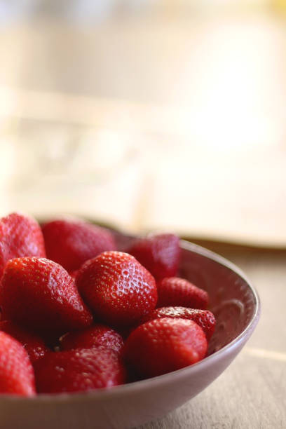 istock Bowl of Strawberries, Open Book and Reading Glasses 1388432445