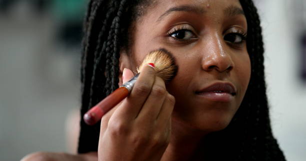istock African black teen applying make-up 1388432518