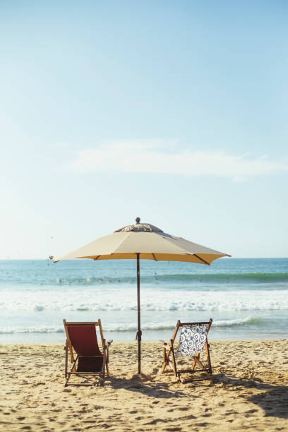 Beach umbrella and beach chairs stock photo