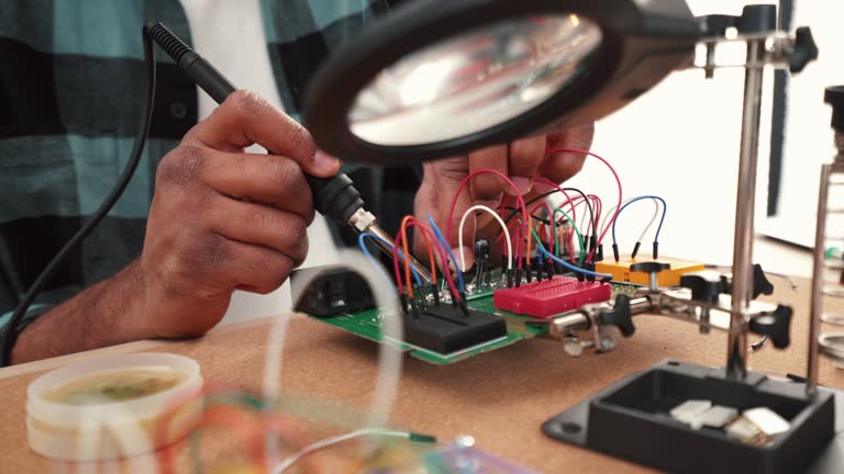 Male working with electrical components.