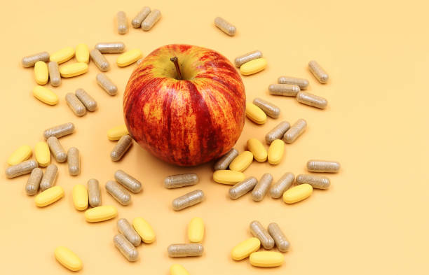 istock A red apple surrounded by probiotic and vitamin pills 1388436935