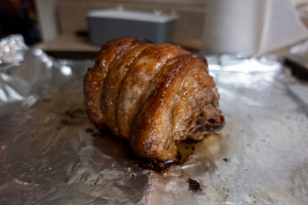 istock Close up, selective focus on a juicy, pork chashu roast resting on tin foil after being cooked 1388439232