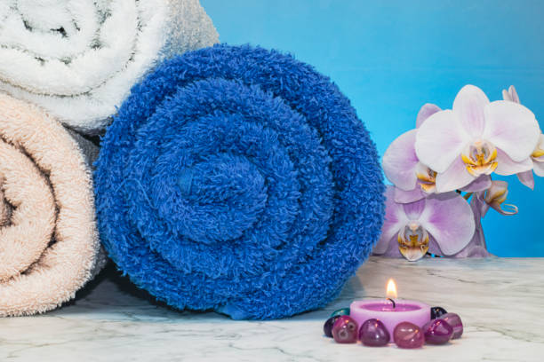 Spa concepts with massage tool, candles, towels and petals