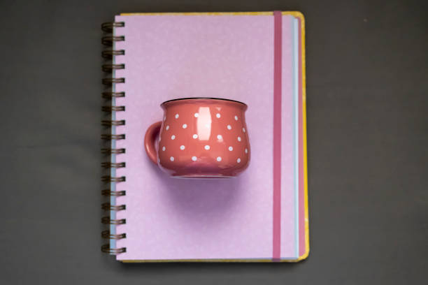 Pink mug with small printed hearts on the pink diary