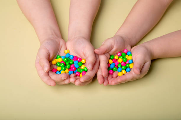 istock bright colorful sweets in children's palms 1388443432