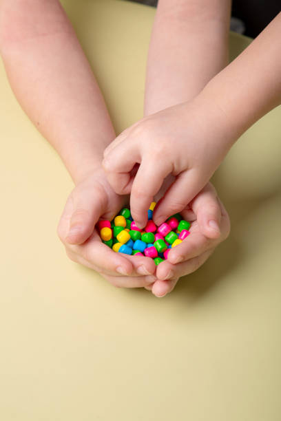 istock bright colorful sweets in children's palms 1388443535