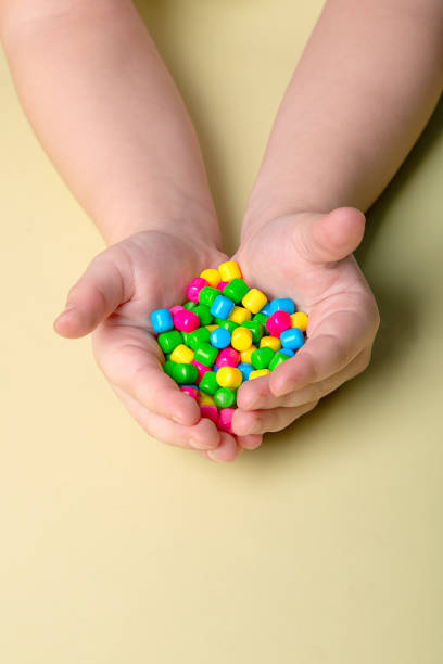 istock bright colorful sweets in children's palms 1388443536