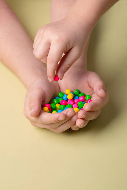 istock bright colorful sweets in children's palms 1388443584