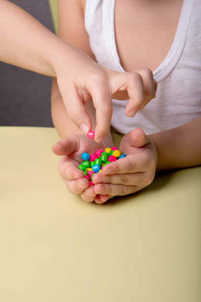 istock bright colorful sweets in children's palms 1388443586