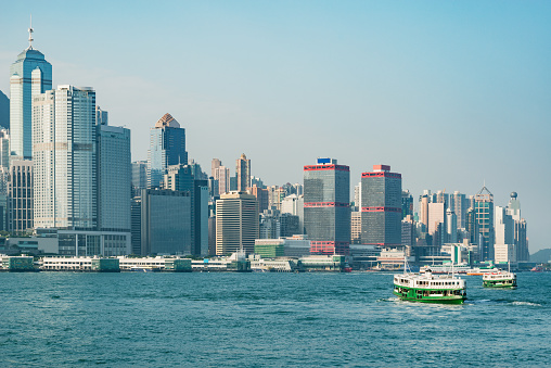 A Star Ferry carries passengers across Victoria Harbour in  Hong Kong. The Star Ferry plies its way between Hong Kong Island and Kowloon.