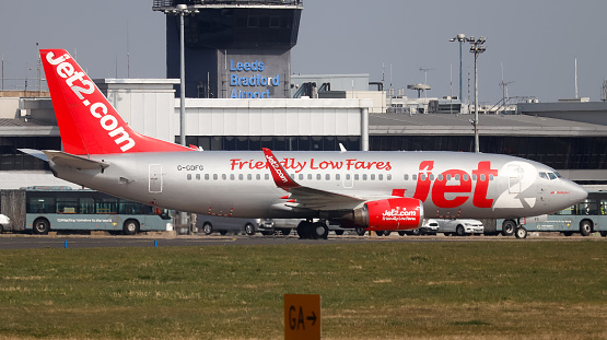 Leeds Bradford Airport, United Kingdom,  24 March, 2022: Jet2 Boeing 737 (G-GDFG) taxiing towards her gate after landing from Geneva, Switzerland.