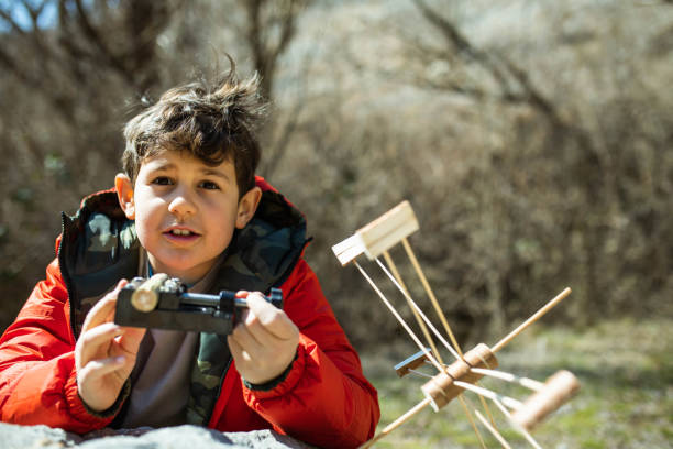 istock A cute boy making a waterwheel from wood 1388446406