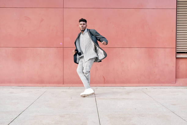 istock african-american man dancing outdoors in casual clothes 1388449121