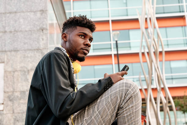 istock young african-american man thoughtfully using his mobile phone 1388449279