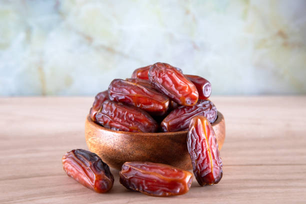istock Bowl of dates fruit on  wooden background 1388451705