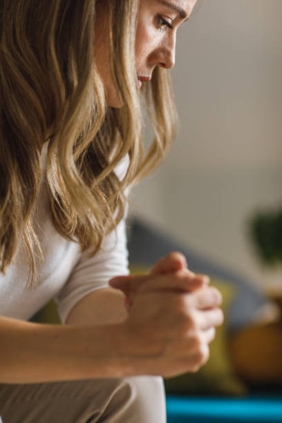 istock Worried young woman looking down and cracking her knuckles 1388452931