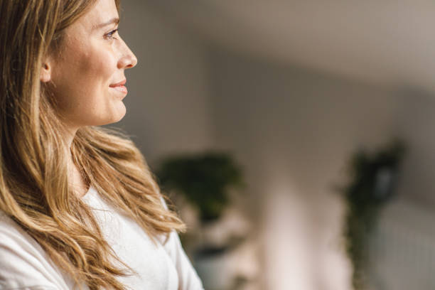 istock Copy space shot of young woman smiling while daydreaming 1388452935