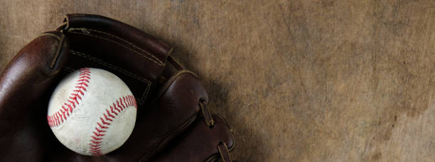 baseball in glove on wooden background - catching horizontal nobody baseballs imagens e fotografias de stock