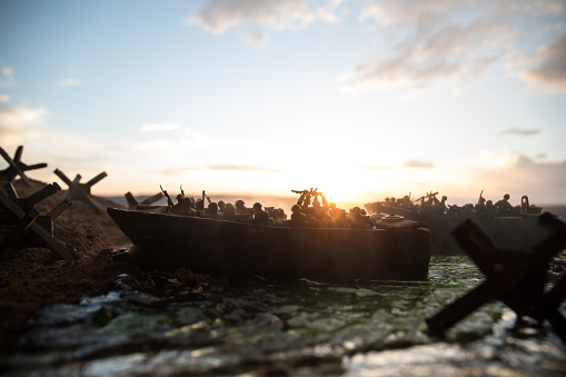 World War 2 reenactment (D-day). Creative decoration with toy soldiers, landing crafts and hedgehogs. Battle scene of Normandy landing on June 6, 1944. Selective focus