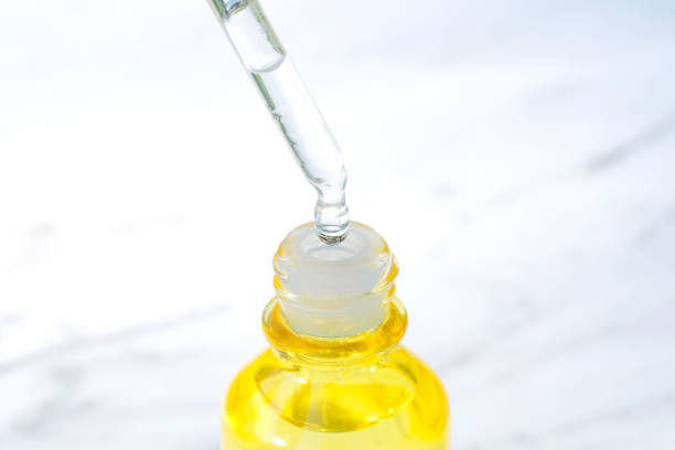 istock Drop face serum Collagen Moisturizer into a clear serum bottle with soft light background Protector skin Treatment facial essence oil, Vitamin C. Beauty and spa Concept. 1388463468