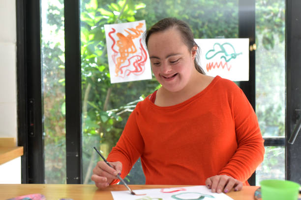 istock girl with syndrome down painting 1388463702