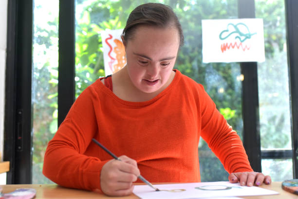 istock girl with syndrome down painting 1388463704