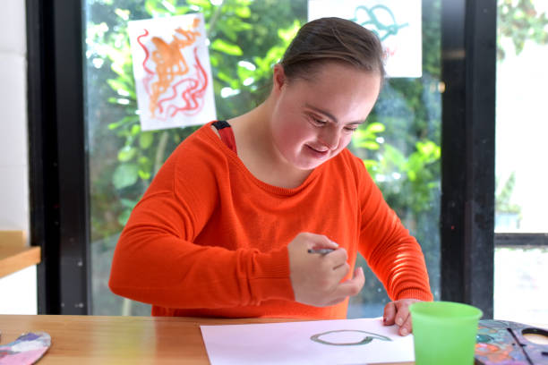 istock girl with syndrome down painting 1388463705