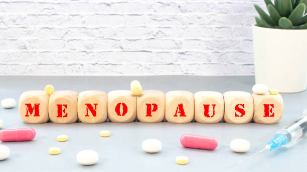menopause word written on wood block. menopause text on table, concept.
