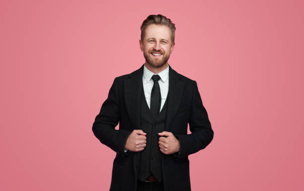 istock Cheerful businessman adjusting elegant jacket 1388469248