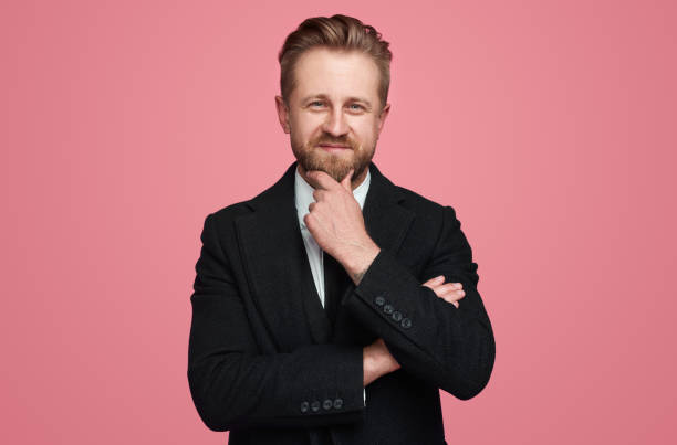 istock Smart male manager rubbing chin 1388469257