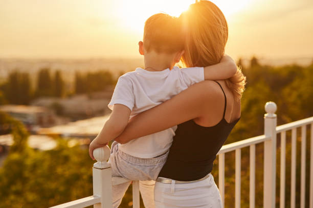 istock Mother and son admiring sunset in summer 1388469304