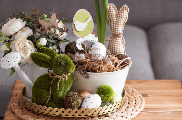 istock Rustic. White-green colors. Iron planters with Easter eggs, flowers, candles and rabbits in the living room interior on the table. The concept of home comfort in the bright holiday of Easter 2022. 1388469627
