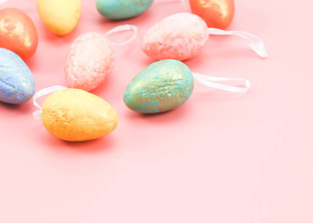istock Multi-colored pastel decorative eggs lie in the upper right corner on a light pink 1388471488