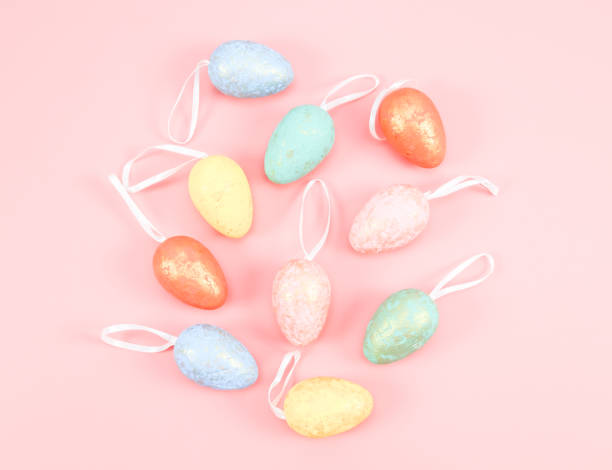 istock Decorative Easter marble eggs of delicate pastel colors lie in the middle on a pink. 1388471521