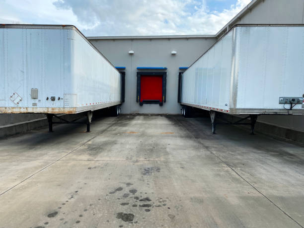 istock truck loading bay dock warehouse empty tailor containers load shipping industry 1388472199