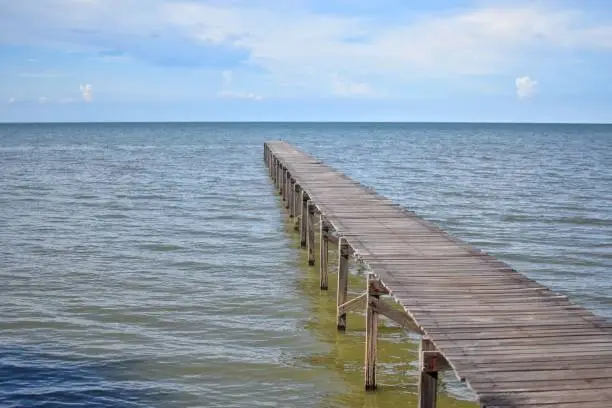 Long wooden bridge that extends into the sea in Laem Phak Bia, Ban Laem District, Phetchaburi, THAILAND.