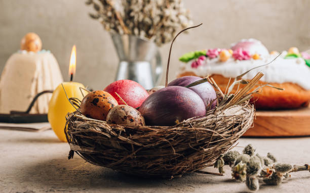 istock Traditional Ortodox Easter background. Easter eggs in a nest on a stone background. 1388480216