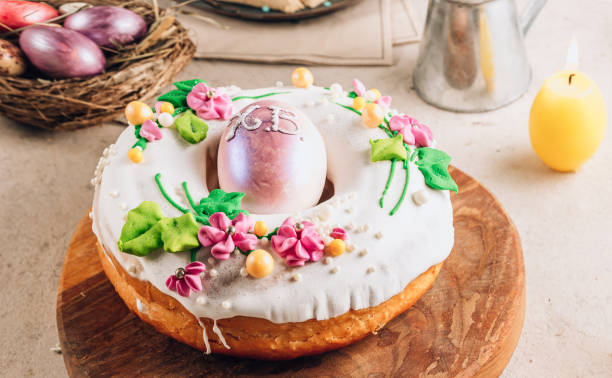 istock Traditionl Easter kulich cake on wooden board over rustic stone background. 1388480234