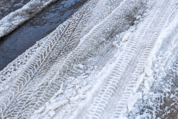 istock Spring road with puddles  of melted snow 1388481454
