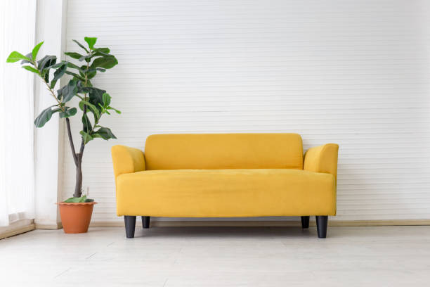 istock White living room interior with modern yellow fabric sofa with empty white wall background 1388484817