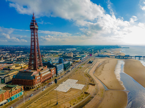 Wide aerial photo from a drone of Walton-on-the-Naze Pier and beach huts on the Essex coast, UK.