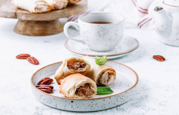 istock Homemade mini apple strudel with pecans and mint on white background. Viennese pastry. 1388486792